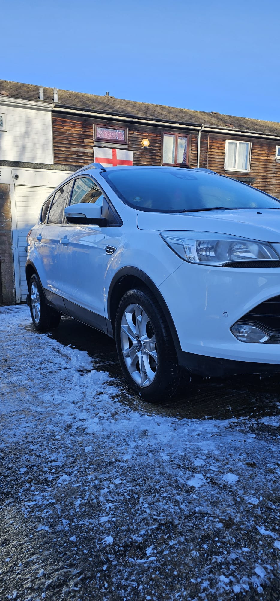 White SUV professionally detailed on a snowy driveway